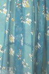 Caroline C0nstas blossoms on teal silk chiffon