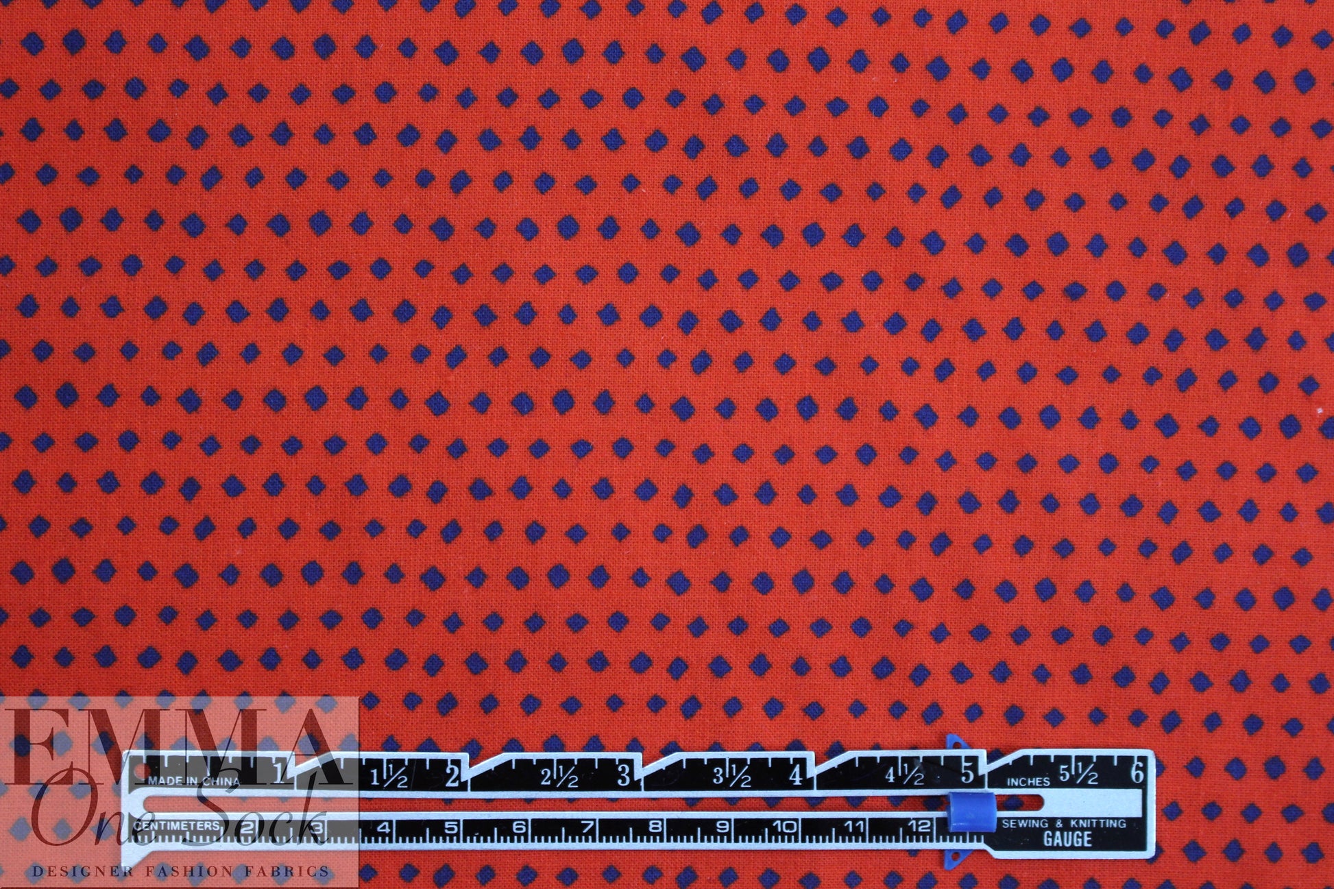 famous designer navy diamonds on red cotton woven