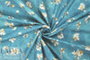 Caroline C0nstas blossoms on teal cotton stretch shirting