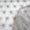 EOS Fabrics smoke gray tulle with textured metallic gold snowflake or floral mesh applique for occasionwear