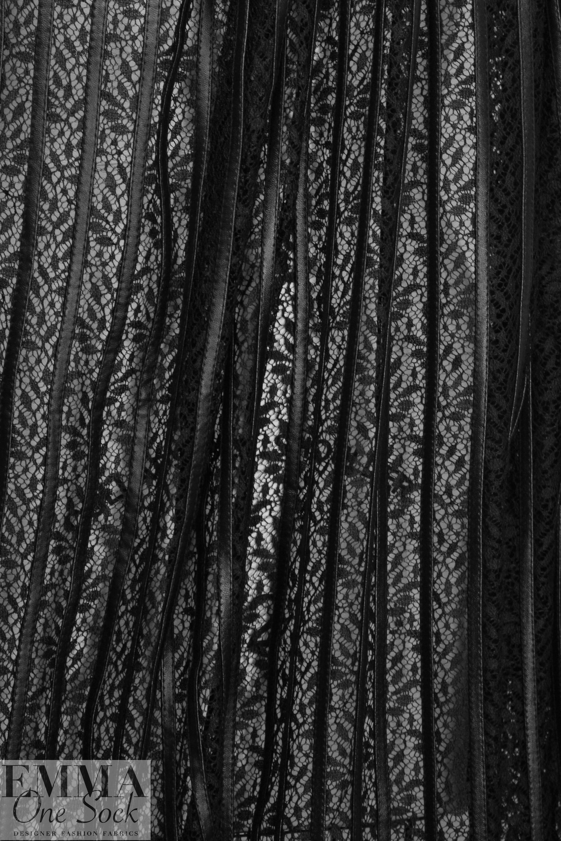NY designer black faux leather strips on lace