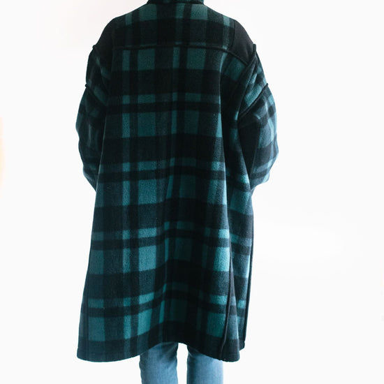 photo of back view of Siberian Parka on model.  she wears the hood up and shows shoulder yoke details