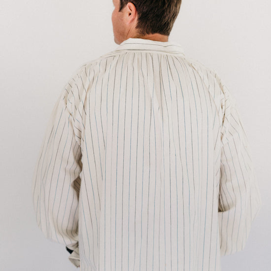 Man standing in front of a white studio backdrop wearing 204 Missouri River Boatman's Shirt.
