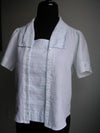 A mannequin wearing 210 Armistice Blouse with rectangle collar.