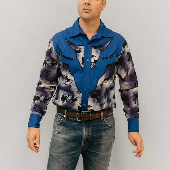 Man standing in front of a white studio backdrop, wearing 212 Five Frontier Shirt with decorative bull's head yoke.