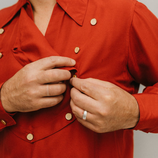Close up of man wearing 212 Five Frontier Shirt buttoning front removable bib.