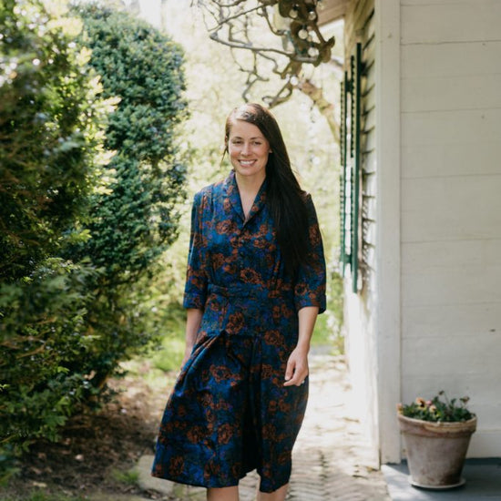 Woman walking surrounded by greenery wearing the 247 Lindy Shirtdress