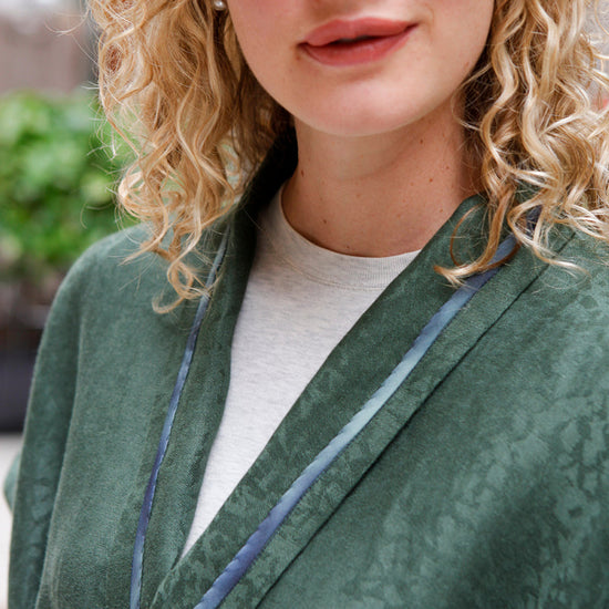close up of blonde white woman v-neck of the 254 Swing Coat.