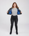 Woman wearing a black jacket with a blue interior, striped shirt, and black pants on a white background. This biker jacket is the Canton Moto Jacket sewing pattern from Cashmerette.