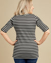 Woman wearing a black and white striped shirt against a beige background. This t-shirt is the Concord T-Shirt sewing pattern from Cashmerette.