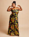 Woman wearing a strapless floral dress on a beige background. This dress is the Ellington Strapless Dress sewing pattern from Cashmerette.