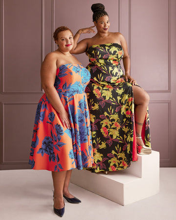 Two women wearing floral strapless dresses against a plain background. This dress is the Ellington Strapless Dress sewing pattern from Cashmerette.