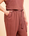 Brown sleeveless top and pants set on a beige background. These pants are the Everett Pants & Shorts sewing pattern from Cashmerette.