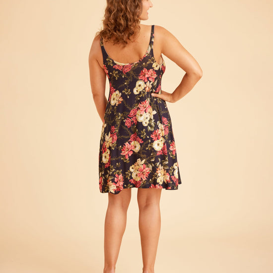 Woman wearing a floral dress on a beige background. This is the Fiske Sleepwear Set sewing pattern from Cashmerette.