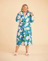 Woman wearing a blue floral robe against a beige background. This is the Fiske Sleepwear Set sewing pattern from Cashmerette.