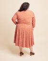 Woman wearing a patterned dress on a beige background. This is the Grafton Dress, Top & Skirt sewing pattern from Cashmerette.