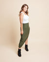 Woman wearing a white top and green skirt against a beige background. This is the Grafton Dress, Top & Skirt sewing pattern from Cashmrette.