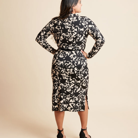 Woman wearing a black and beige floral dress against a beige background. This is the Grafton Dress, Top & Skirt sewing pattern from Cashmrette.