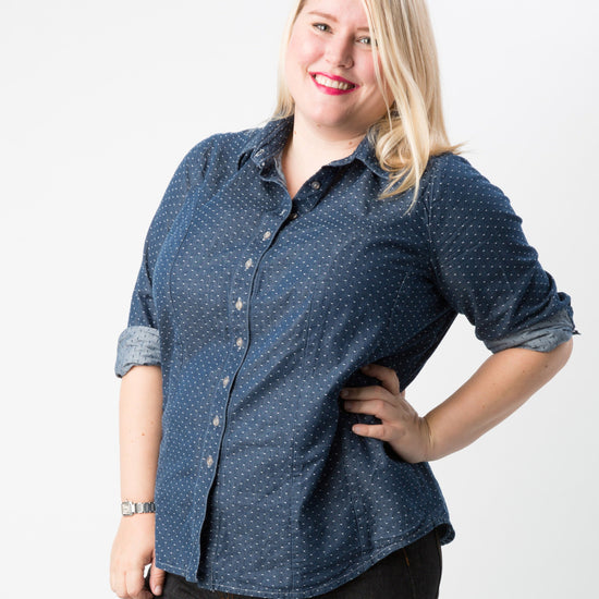 Woman wearing a blue patterned shirt on a white background. This button-up shirt is the Harrison Shirt sewing pattern from Cashmerette.