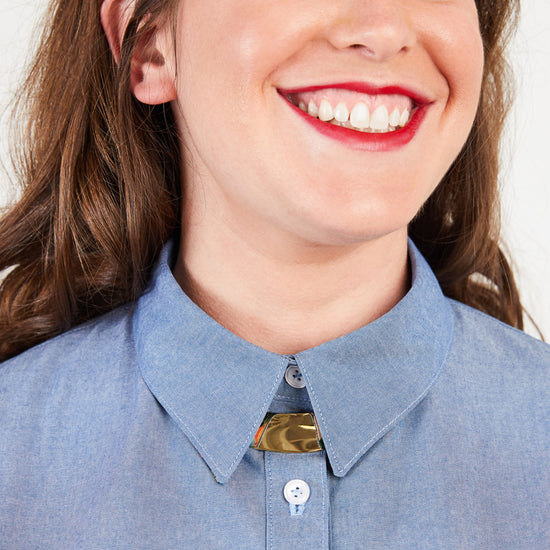 Close-up of a person wearing a blue shirt with a collar. This button-up shirt is the Harrison Shirt sewing pattern from Cashmerette.