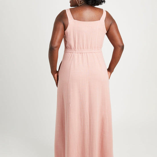 Woman wearing a pink sleeveless dress on a white background. This is the Holyoke Maxi Dress & Skirt sewing pattern from Cashmerette.