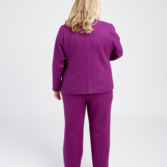 Person wearing a purple outfit on a white background. These pants are the Meriam Trousers sewing pattern from Cashmerette.