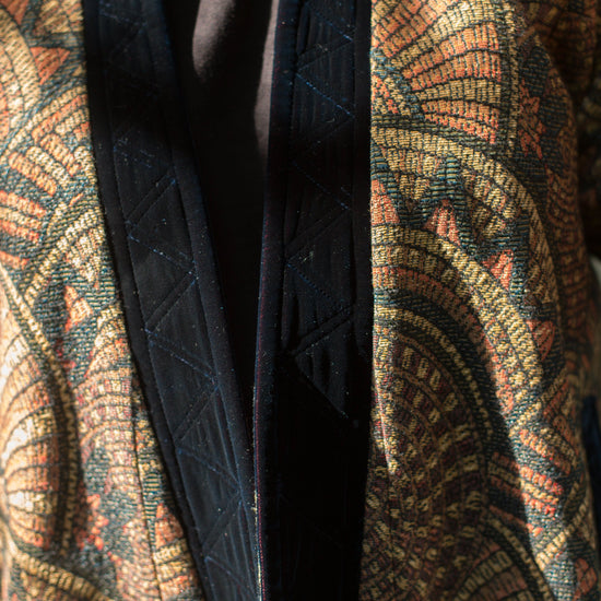 Close up photo of front opening.  Front outer facing is black velvet and quilted using trapunto stitching.