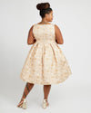 Woman wearing a beige floral dress on a white background. This dress is the Upton Dress & Skirt sewing pattern from Cashmerette.