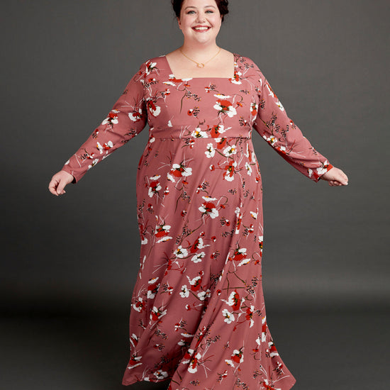 Woman wearing a long floral dress against a gray background. This dress is the Upton Dress & Skirt sewing pattern from Cashmerette.