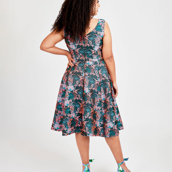 Woman wearing a floral dress on a white background. This dress is the Upton Dress & Skirt sewing pattern from Cashmerette.