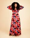 Woman wearing a colorful patterned dress on a beige background. This dress is the Upton Dress & Skirt sewing pattern from Cashmerette.