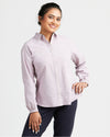 Woman wearing a light purple button-up shirt and dark pants on a white background. This top is the Vernon Shirt sewing pattern from Cashmerette.
