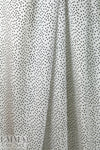 famous designer silk crepe de chine - black dot on cream .625 yds