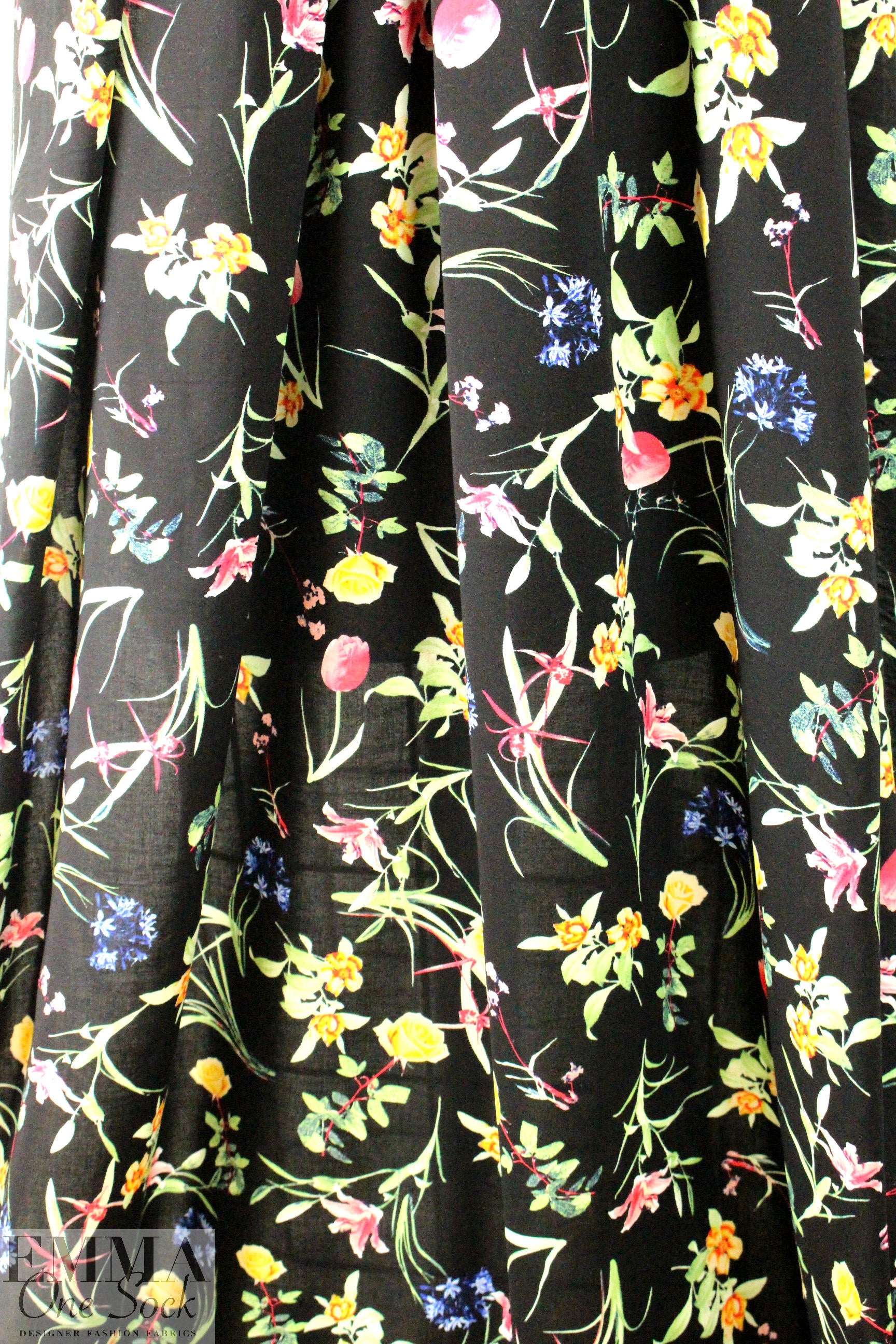 spring flowers on black drapey viscose woven