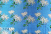 famous designer flowers on blue viscose brocade