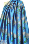 famous designer flowers on blue viscose brocade